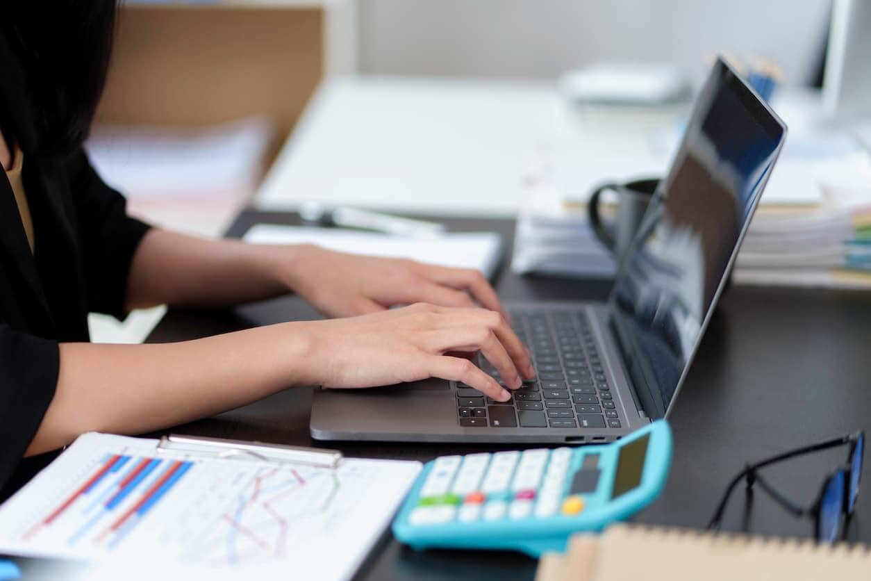 Close-up of business woman typing on his laptop computer in the office